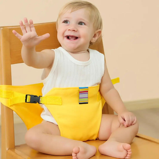 Baby sitting safely on a chair with the harness