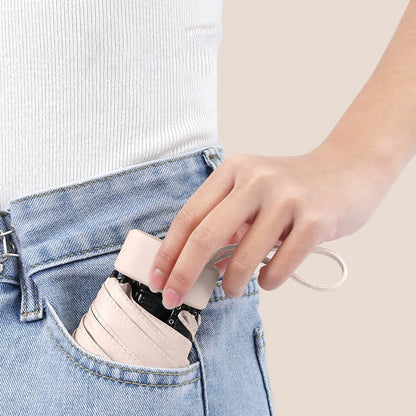 Folded mini umbrella fitting in a jeans pocket