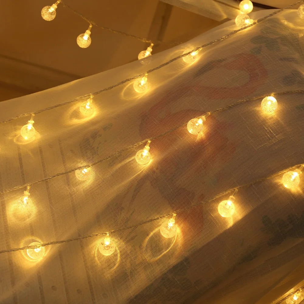 Crystal ball string lights on a sheer curtain